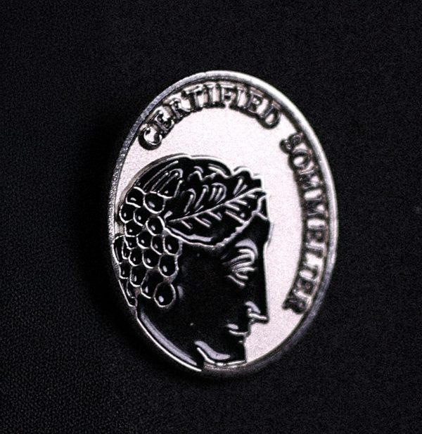 The Court of Master Sommeliers Certified Sommelier pin, silver, on a black lapel